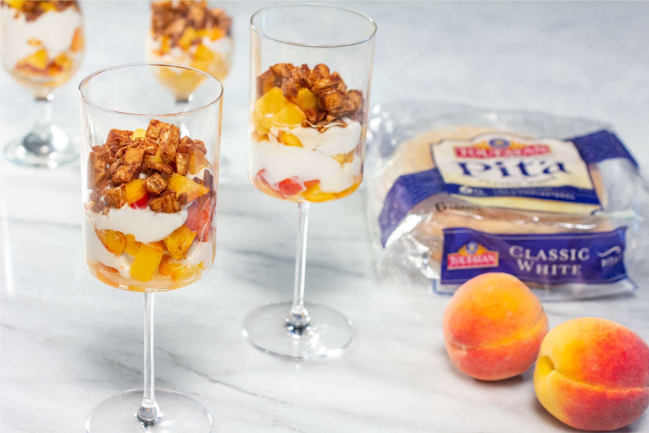 Greek Style Peach Parfait with Cinnamon Pita Crumbles Landscape Side Angle with Product